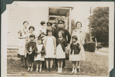 Women and children with two men in uniform (ddr-densho-355-551)
