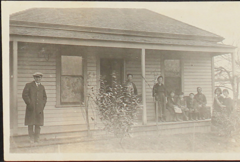 Family posing on porch (ddr-densho-278-152)