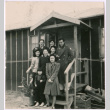 Japanese American men, women, and a boy near barracks steps (ddr-densho-362-7)