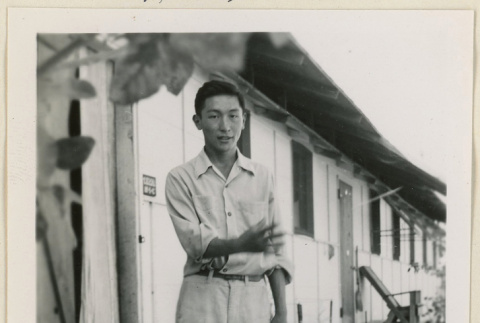 James Nakamura outside a barrack (ddr-densho-37-901)