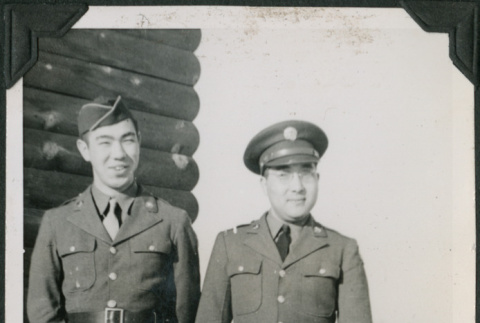 Two men in uniform outside camp building (ddr-ajah-2-518)