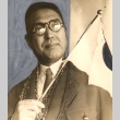 A man holding a Japanese flag (ddr-njpa-4-2493)