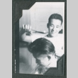 Ken Murakami giving Bill Makamura a haircut (ddr-densho-442-256)