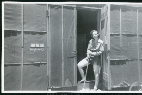 Photograph of Jone Ingalls standing in a barracks doorway (ddr-csujad-47-175)