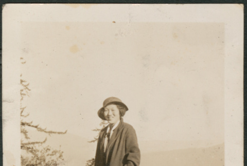 Woman standing by railing (ddr-densho-316-114)