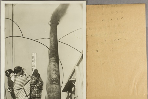 Cut-out of women looking through binoculars pasted onto a photo of a smokestack (ddr-njpa-13-1463)