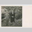 Man and woman standing in front of tree (ddr-densho-332-30)