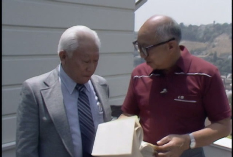 Harry Akune and Jim Ariyasu on balcony (ddr-densho-1007-1595)