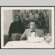 George Hirahara blowing out candles on a cake (ddr-densho-293-105)