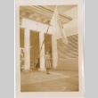 Tomoye (Nozawa) Takahashi standing in front of Japanese Pavilion at the Golden Gate International Exposition by Japanese flag (ddr-densho-426-2145)