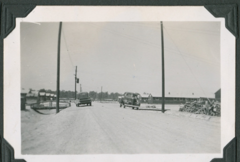 Cars on dirt road (ddr-densho-471-32)