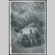Photograph of three people sitting on a bumper in a canyon in Death Valley (ddr-csujad-47-122)