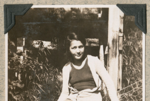Woman sitting on fence (ddr-densho-383-235)