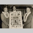 Three men holding a Pan American publicity poster (ddr-njpa-2-598)