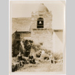 Four people sitting outside Carmel Mission Church (ddr-densho-426-1977)