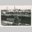 A woman sitting on a bench outside (ddr-densho-338-86)