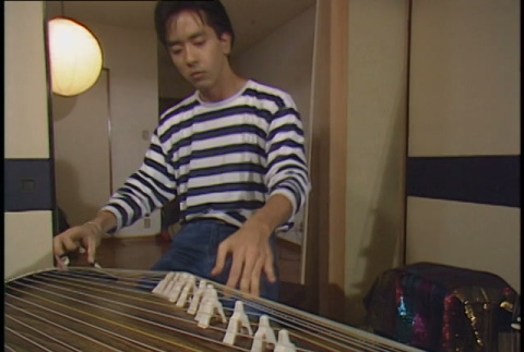 Taiko performance, part 2 of 2; exterior Tokyo footage; Brian Yamakoshi koto setup and performance, part 1 of 2 (ddr-densho-1007-1724)
