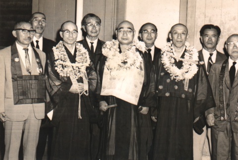 Buddhist priests wearing robes and leis posing with others (ddr-njpa-4-204)
