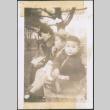 Woman and two children sitting on a bench (ddr-densho-483-1088)