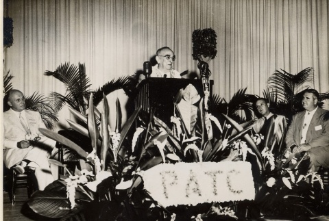 Samuel Wilder King giving a speech in front of three men seated on a stage (ddr-njpa-2-544)