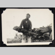 Man holding a log (ddr-densho-542-758)