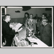 Man at podium reading a document (ddr-densho-293-173)