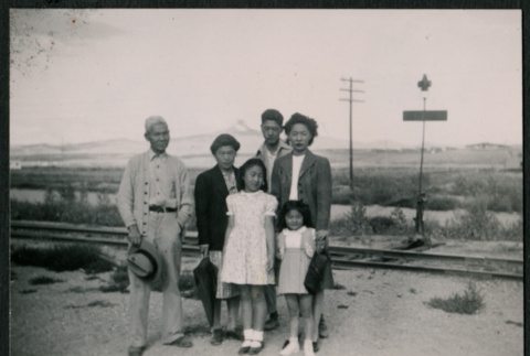Six Japanese Americans at railroad crossing (ddr-densho-362-42)