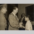 A man shaking hands with a boy (ddr-njpa-1-514)