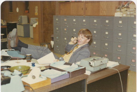 Man in office with feet on desk (ddr-densho-426-144)