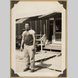 Roy Sugino outside a barrack (ddr-densho-542-518)