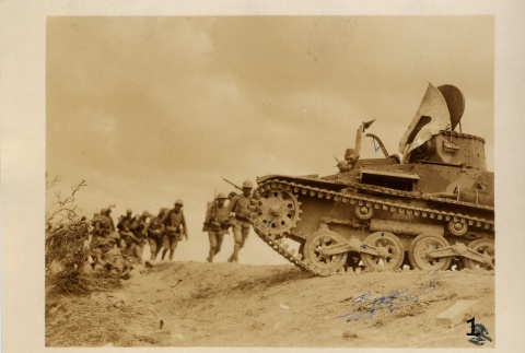 Soldiers walking towards a tank (ddr-njpa-6-98)