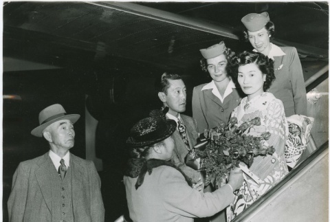 (Photograph) - Image of group of people on aircraft ramp welcoming woman in kimono (PDF) (ddr-densho-332-36-mezzanine-0fd7598685)