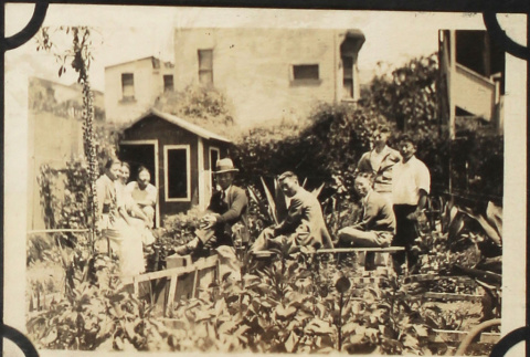 Group in garden with shed in back (ddr-densho-423-516)
