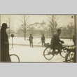 Civilians riding bicycles past two sentries with rifles (ddr-njpa-13-1225)
