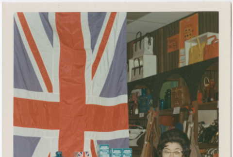 Tomoye Takahashi standing by display of British themed products (ddr-densho-426-1090)