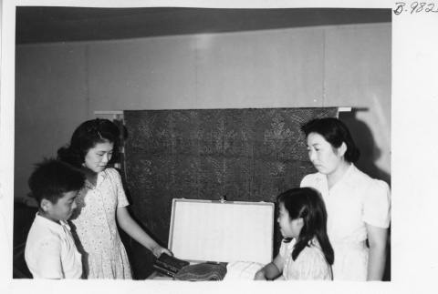 Kikoye Yokagawa and her children preparing to leave for Tule Lake (ddr-fom-1-920)