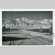 Photograph of snow-covered Manzanar street with barracks on both sides (ddr-csujad-47-53)