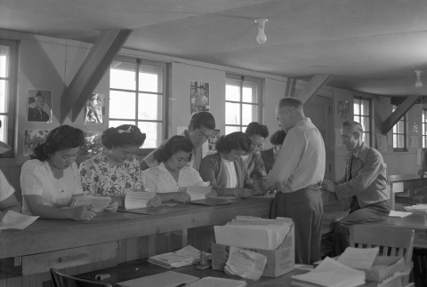 Group reading documents in an office barracks (ddr-fom-1-392)