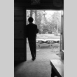 A camper standing in the doorway of the mess hall (ddr-densho-336-210)