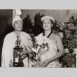 An Aloha Week king holding a trophy and queen holding an orchid (ddr-njpa-2-571)