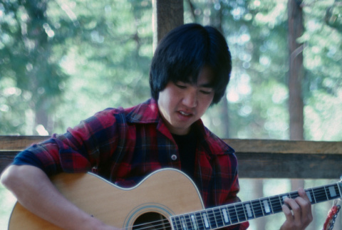 Brad Shirakawa playing guitar (ddr-densho-336-1487)