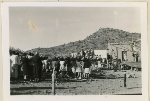 Crowd saluting an American flag (ddr-densho-37-967)