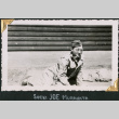 Man sitting on ground (ddr-densho-434-335)