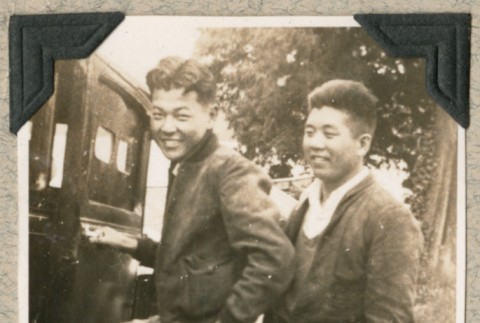 Two men standing next to car (ddr-densho-383-198)