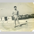 Frank Takao holding a gun and sword (ddr-densho-22-351)