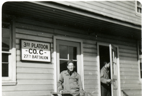 Tom Kubota in front of 3rd Platoon Co. C 27th Battalion sign (ddr-densho-354-1996)