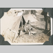 Man sitting outside tent (ddr-ajah-2-262)