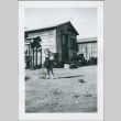 A toddler in front of MacDonald Hill cabins (ddr-densho-300-71)