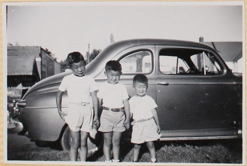 Three boys standing by car (ddr-densho-522-74)