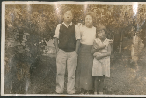 Woman with boy and girl standing in yard (ddr-densho-316-196)